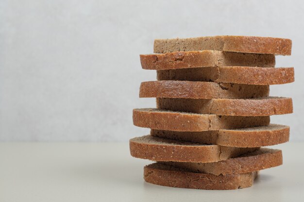 Sliced fresh brown bread on white background. High quality photo