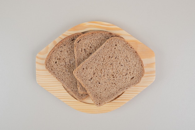 Sliced fresh brown bread on white background. High quality photo