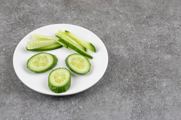 Sliced fresh cucumbers on white plate