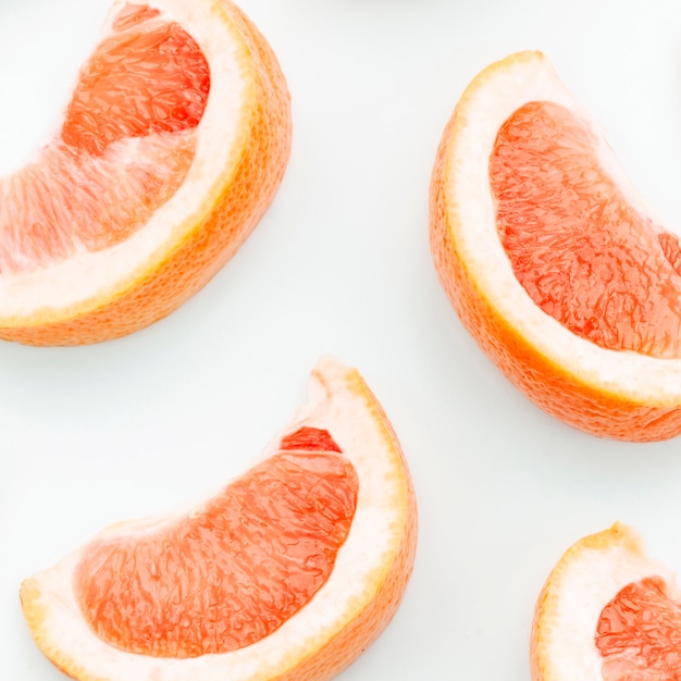 Sliced fresh grapefruit on white background