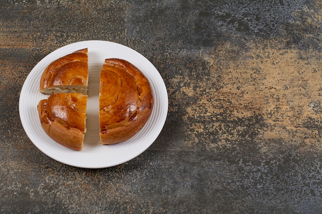 Sliced fresh pastry on white plate. 