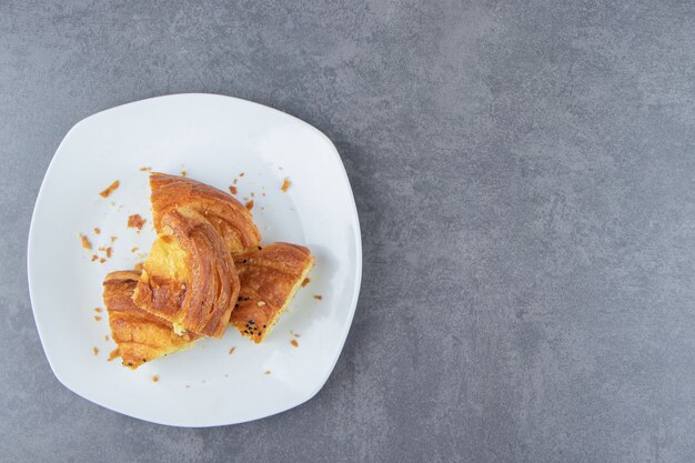 Sliced fresh pastry on white plate. 