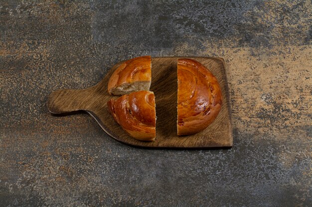 Sliced fresh pastry on wooden board