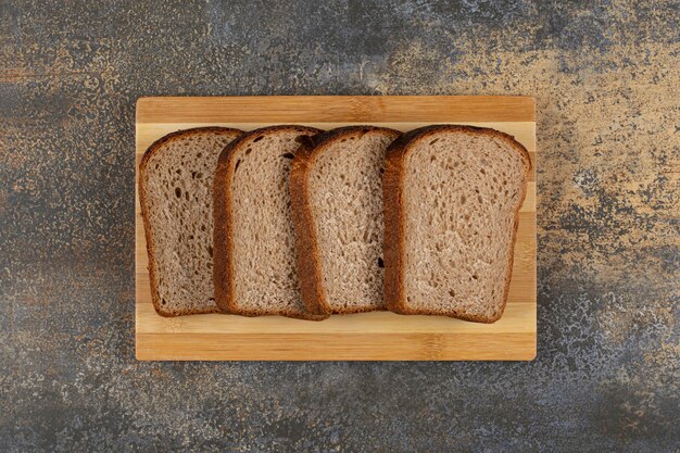 Sliced fresh rye bread on wooden board