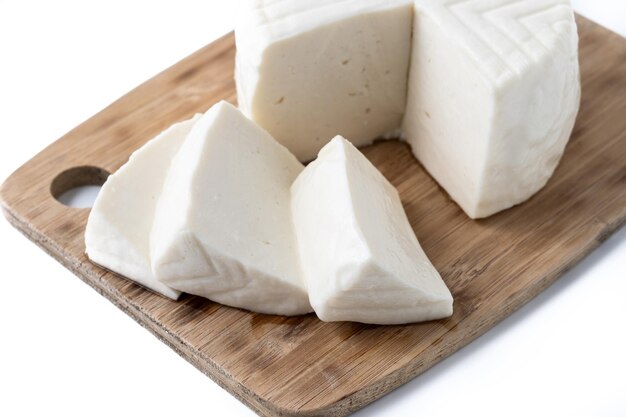 Sliced fresh white cheese from cow's milk isolated on white background