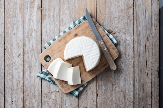 Sliced fresh white cheese from cow's milk on white background