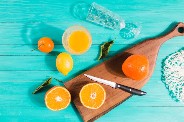 Sliced fruits and juice glasses on table