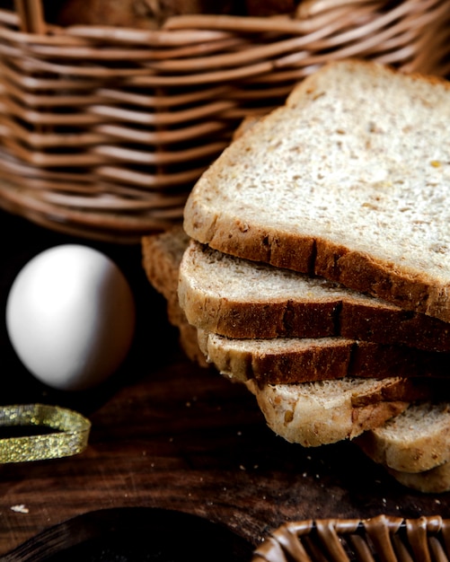 Sliced gray bread and egg