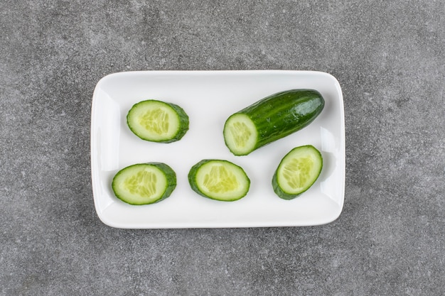 Sliced healthy cucumber slices on white plate