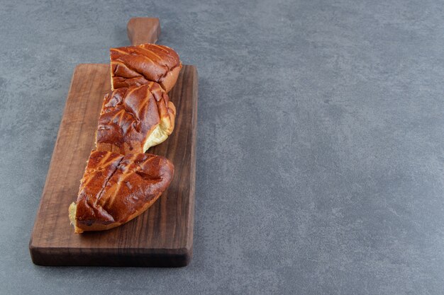 Sliced homemade fresh pastries on wooden board. 