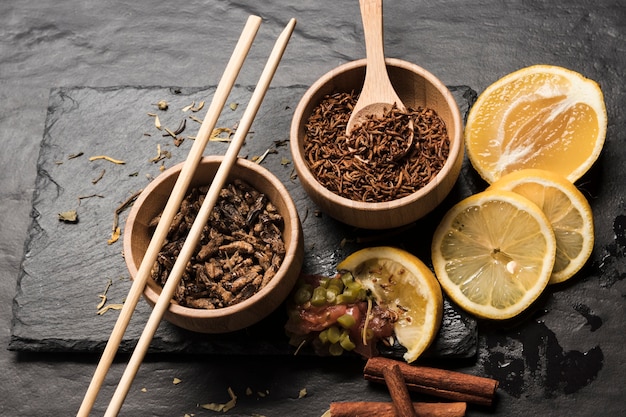 Sliced lemons with wooden bowls filled with insects 
