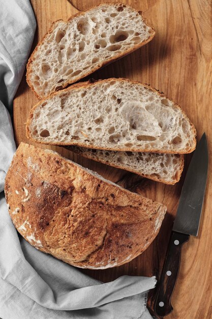 Sliced loaf of artisan sourdough bread on a cutting board Top view vertical frame