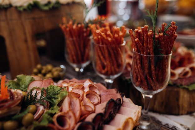 Sliced meat and other snacks are on the table