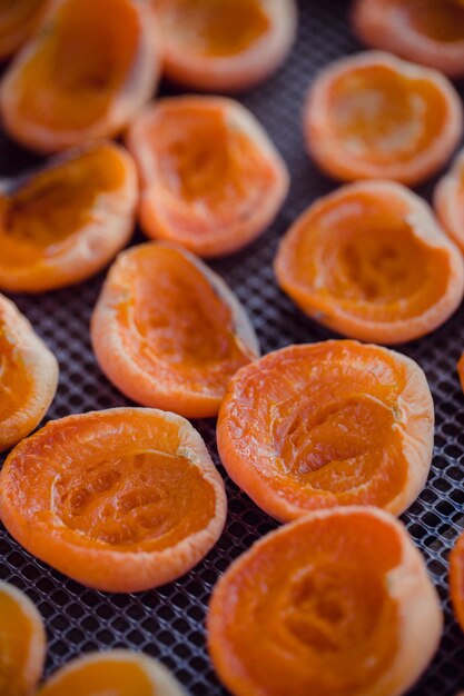 Sliced orange fruit on black metal tray