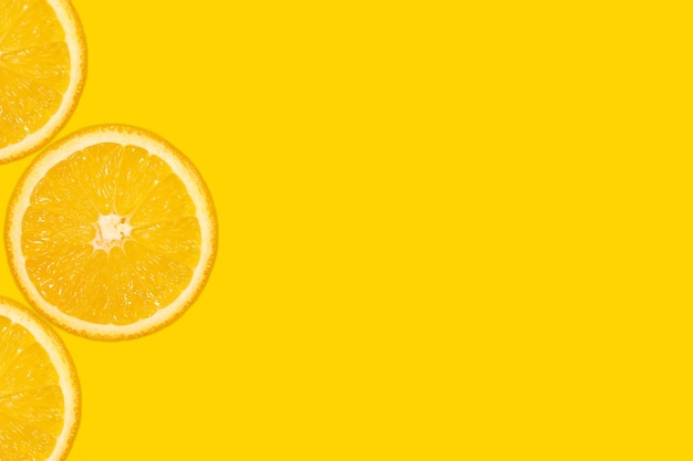 Нарезанный апельсин, желтый фон, копия пространства. свежие сочные фрукты, источник витамина с. яркий фон.