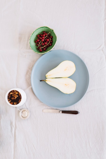 Sliced pear and cherries in composition