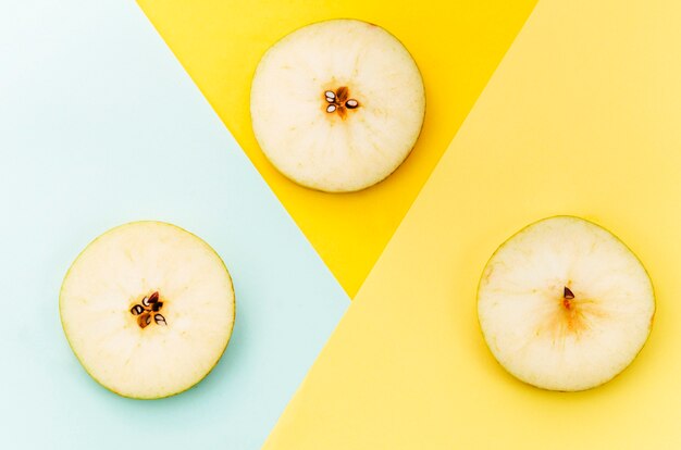 Sliced pear on colored background