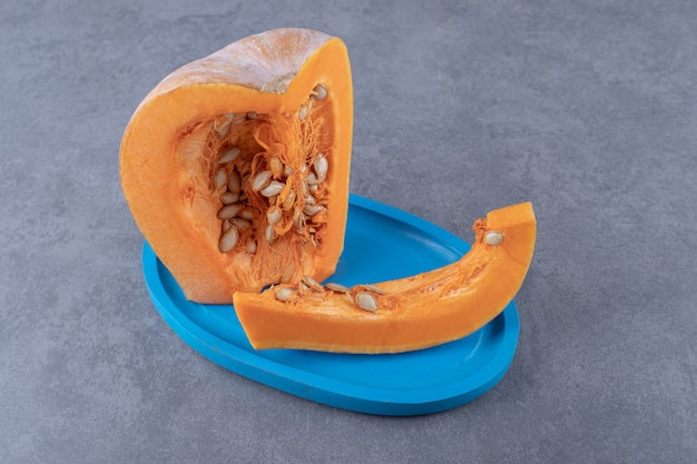 a sliced of pumpkin, on the tray , on the marble surface.