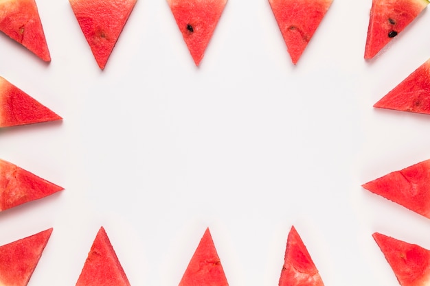 Sliced red watermelon on white surface