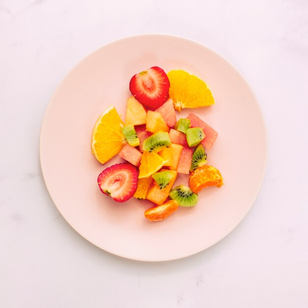 Sliced ripe exotic fruits on plate