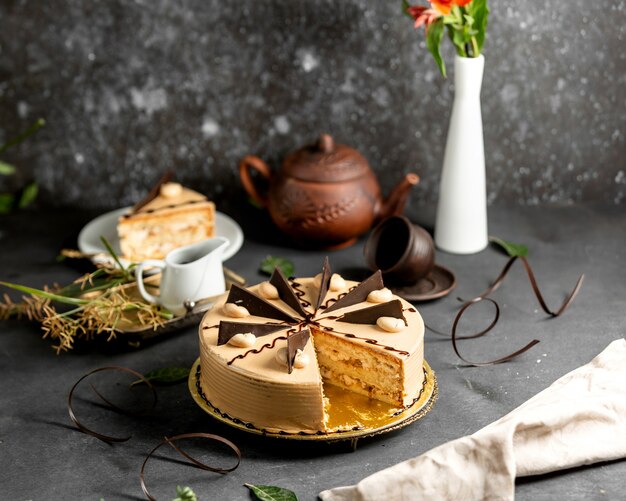 Sliced round cake with coffee cream and chocolate pieces