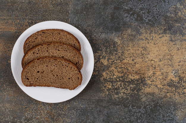 Sliced rye bread on white plate