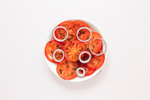 Sliced tomatoes and onions in plate