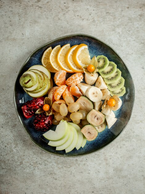 Sliced various mixed fruits on plate