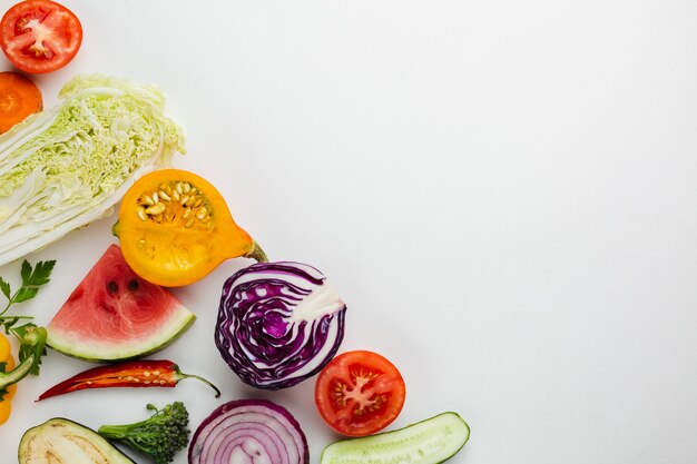 Sliced veggies on white background with copy space
