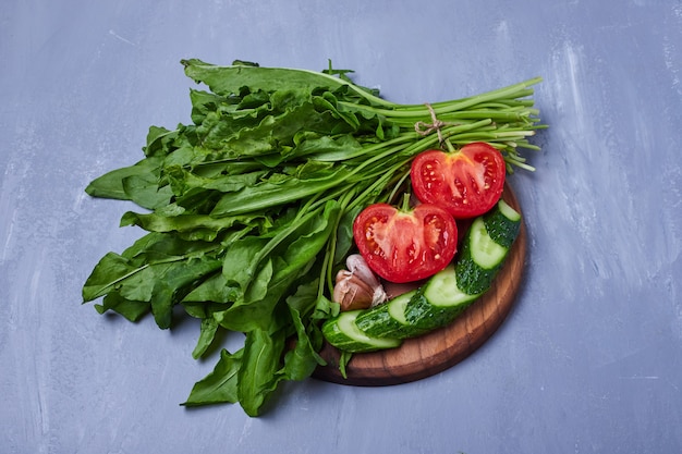 Sliced vegtables and herbs on blue