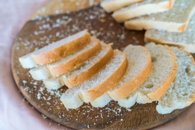 Sliced white bread on wood