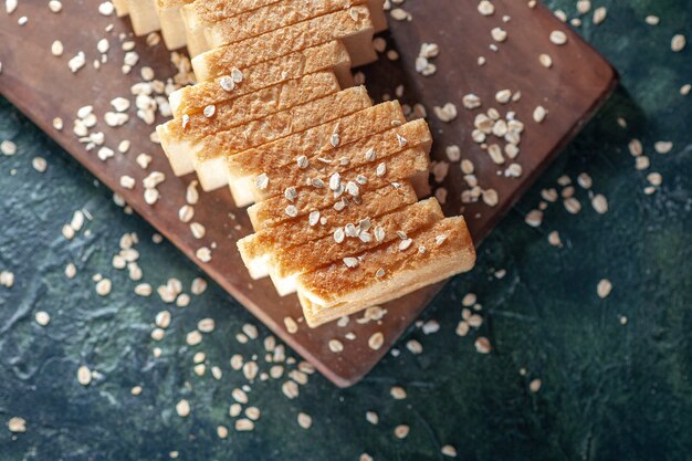 Sliced white breads with seeds on wooden board