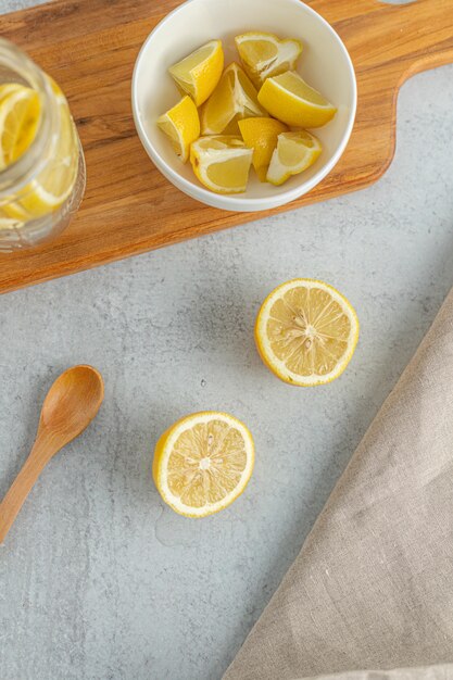 Sliced yellow lemon on bowls and jar