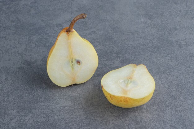 Sliced yellow pear isolated on gray surface