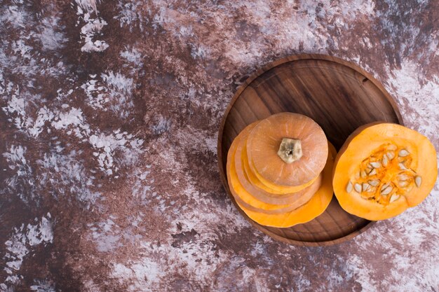 Sliced yellow pumpkin with seeds inside