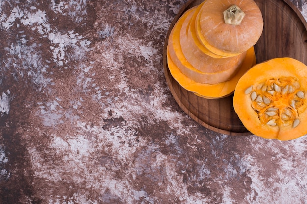 Sliced yellow pumpkin with seeds inside