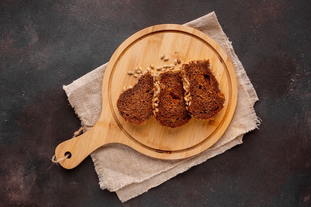 Slices of baked bread on wooden board