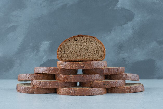 Slices of black bread on stone table