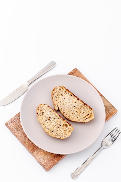 Slices of bread on plate and cutlery copy space