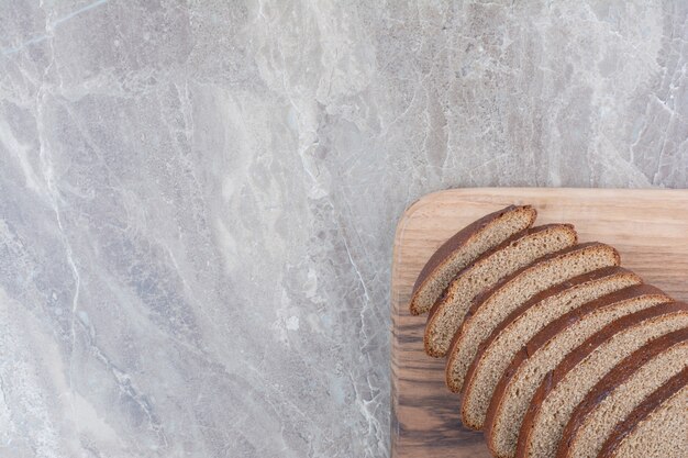 Slices of brown bread on marble surface