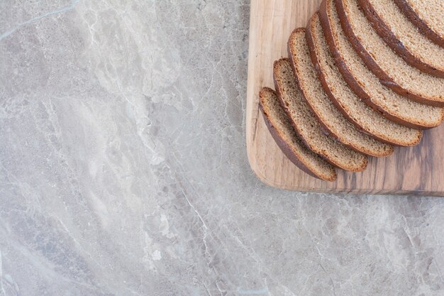 Slices of brown bread on marble surface