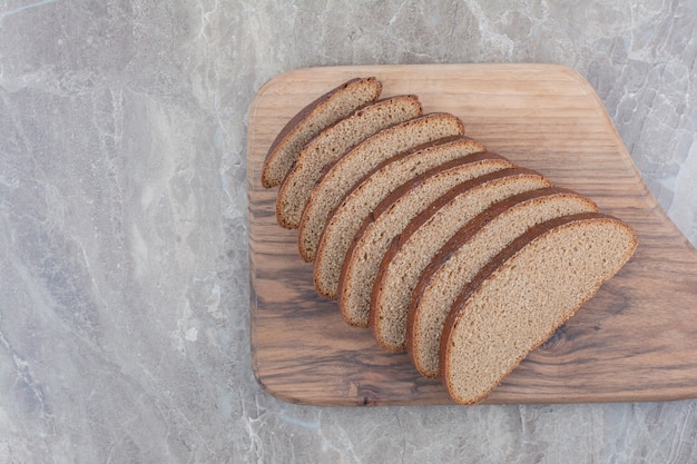 Slices of brown bread on marble surface