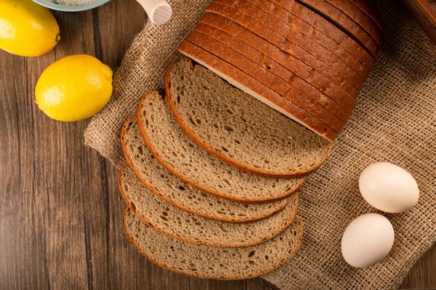 Slices of brown bread with lemons and eggs