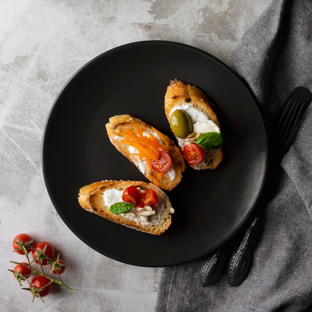 Slices of bruschetta on black plate