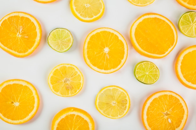 Slices of citruses on white background