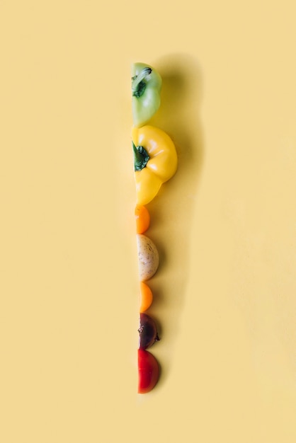 Slices of colorful vegetables on yellow background