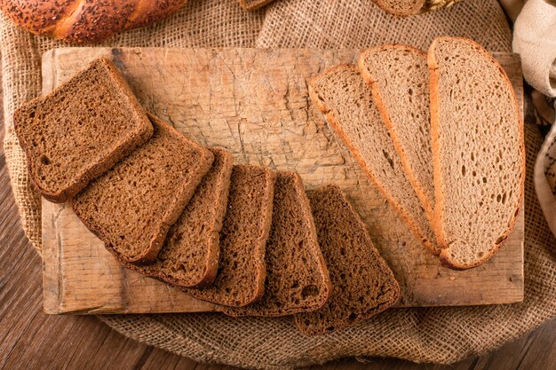 Slices of dark and white bread on the kitchen board