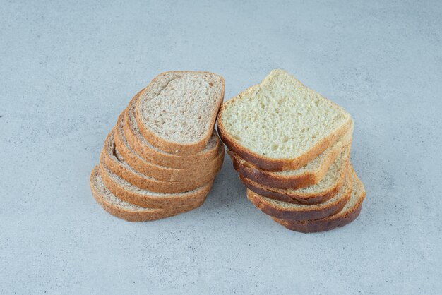 Slices of fresh bread on stone surface