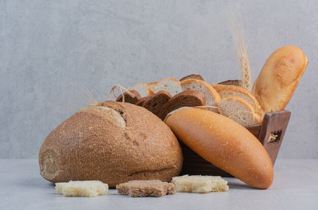 Slices of fresh breads on marble background.