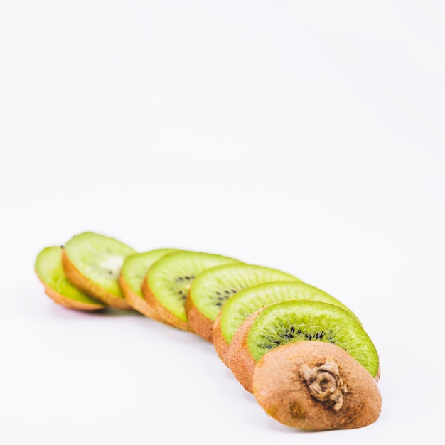 Slices of fresh kiwi fruits on white background